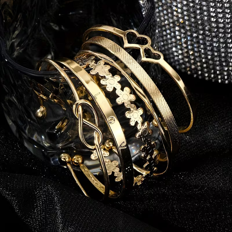 A Set Of Six Fashionable Golden Open Cuff Bracelets For Women