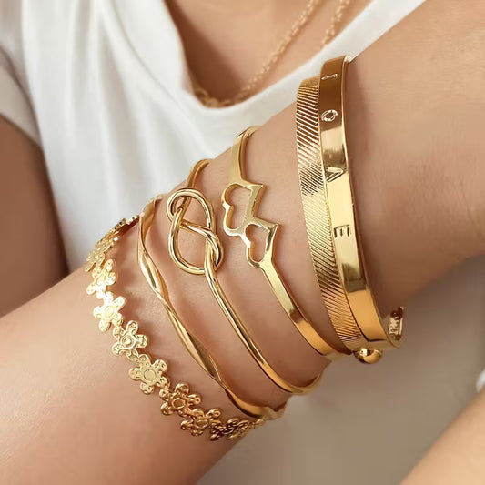 A Set Of Six Fashionable Golden Open Cuff Bracelets For Women