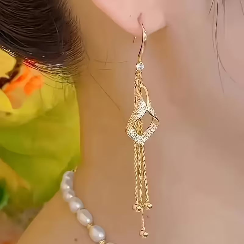 A Set of Stylish And Opulent Women'S Earrings Designed Like Golden Tassel Skirts