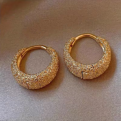 A Pair of Minimalist And Stylish Round Earrings in Matte Golden