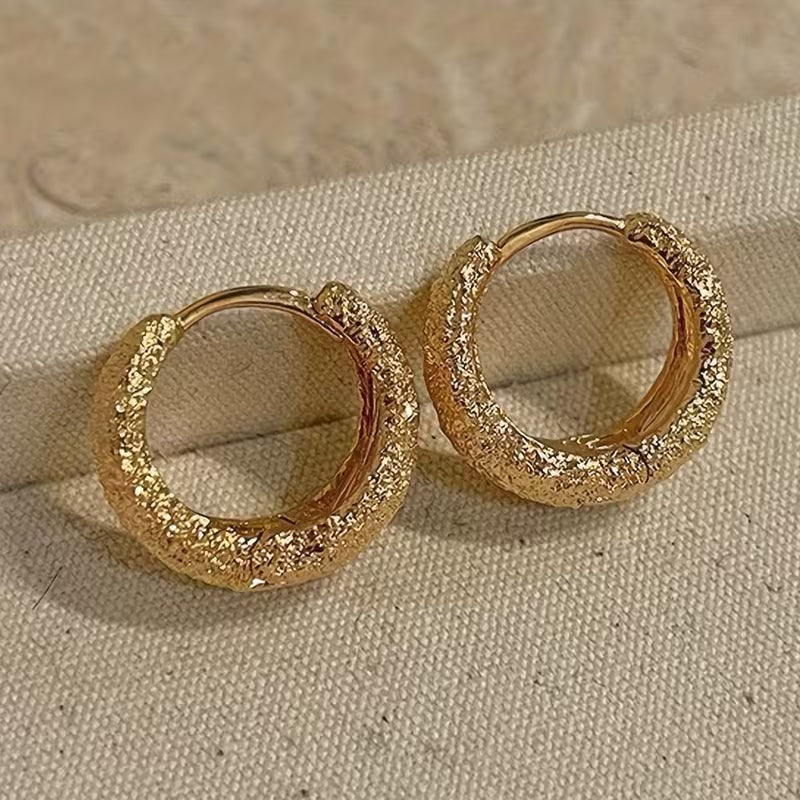 A Pair of Minimalist And Stylish Round Earrings in Matte Golden