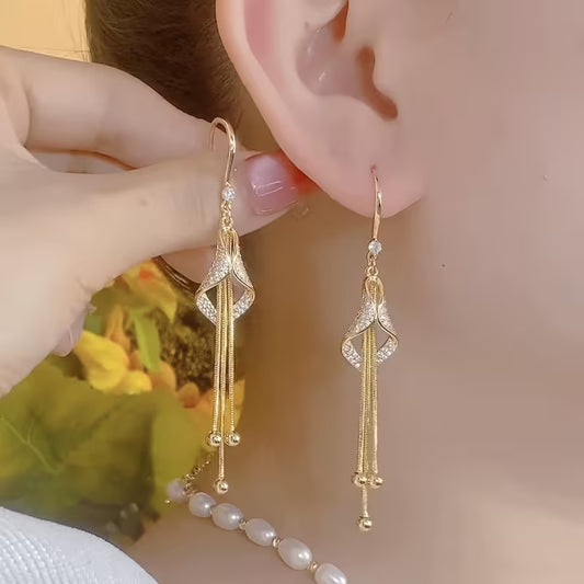 A Set of Stylish And Opulent Women'S Earrings Designed Like Golden Tassel Skirts