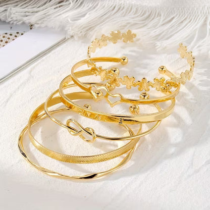 A Set Of Six Fashionable Golden Open Cuff Bracelets For Women