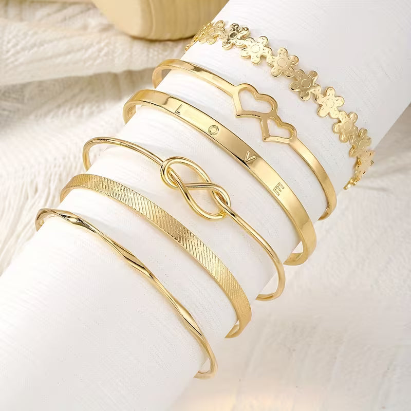 A Set Of Six Fashionable Golden Open Cuff Bracelets For Women