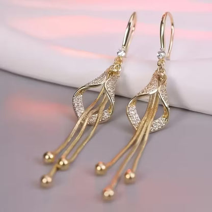 A Set of Stylish And Opulent Women'S Earrings Designed Like Golden Tassel Skirts